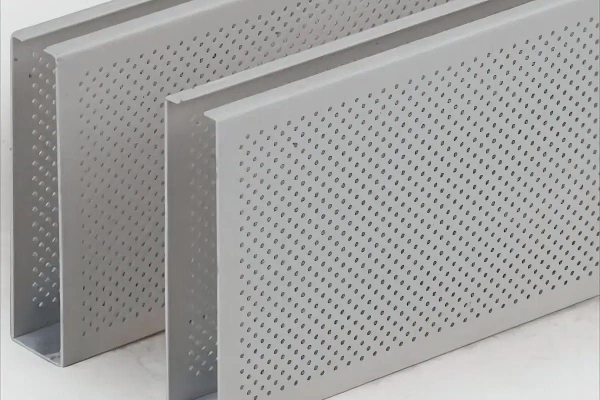 Two rectangular metal panels with a perforated pattern of small, evenly spaced holes, standing upright on a light background.